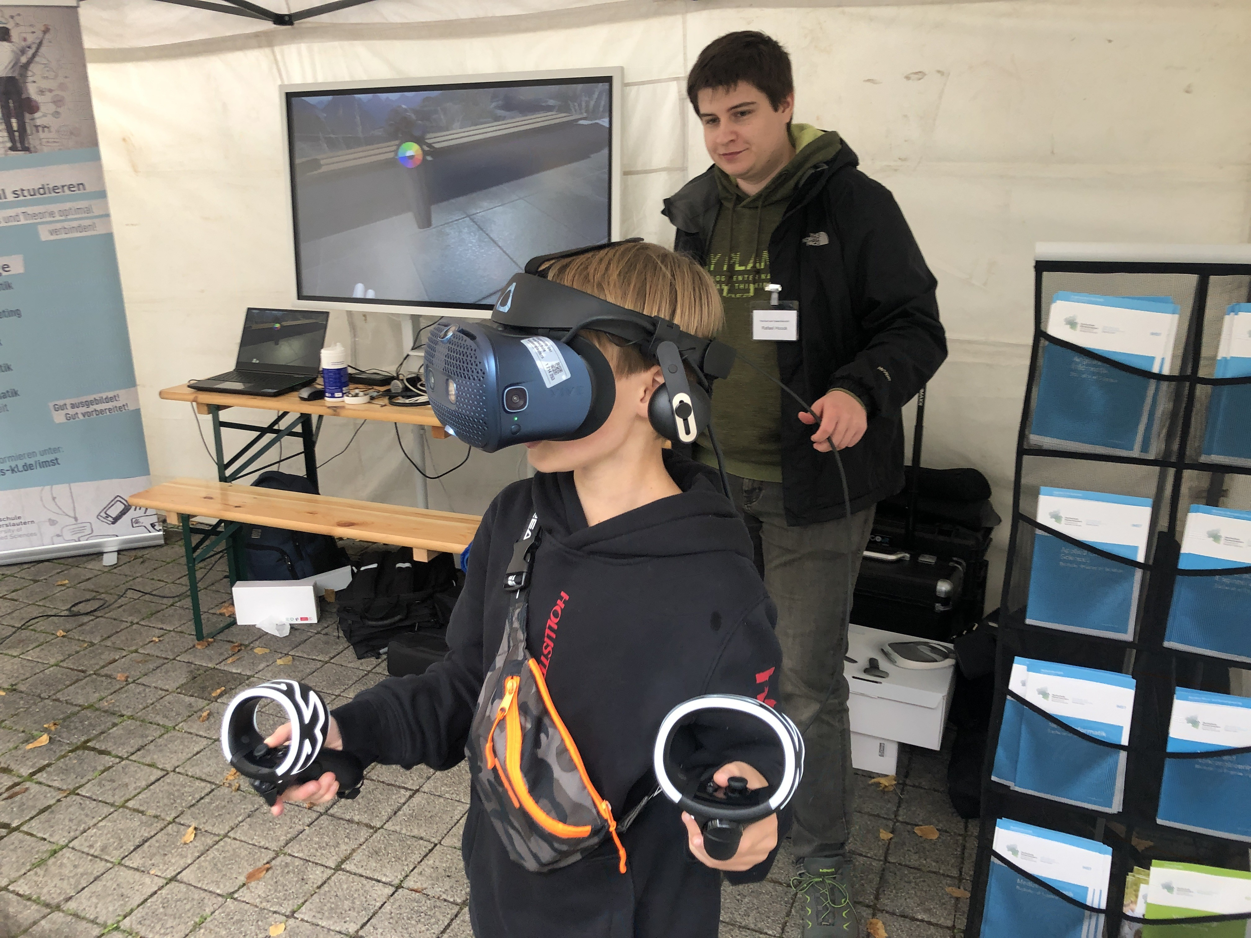 Ein Junge trägt eine VR Brille und hat zwei Controller in den Händen